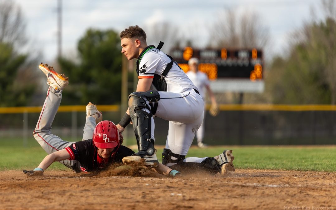     Harlem catcher Aadan Harambesic tags out a runner at home plate in the Huskies’ 27-0 win over Auburn on Monday.